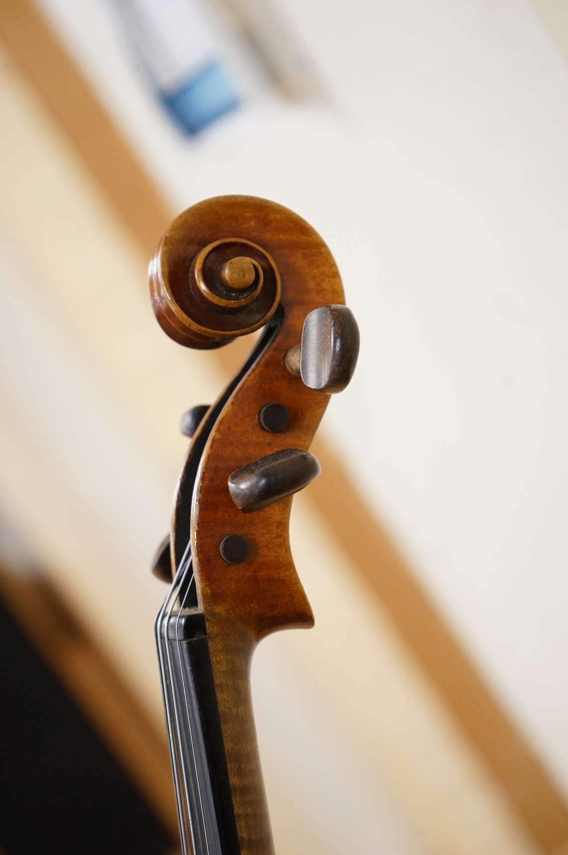 Three cased violins; a German Dresden violin, supplied by Campbell and co., Glasgow, together with another Dresden Stradivarius copy, and the remains of a European violin.
